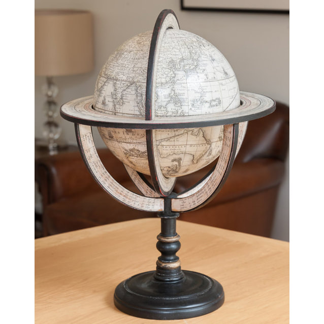 black based globe with a hand painted globe sitting on a table