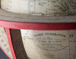 detail of globe cartouche from globe makers Lander and May