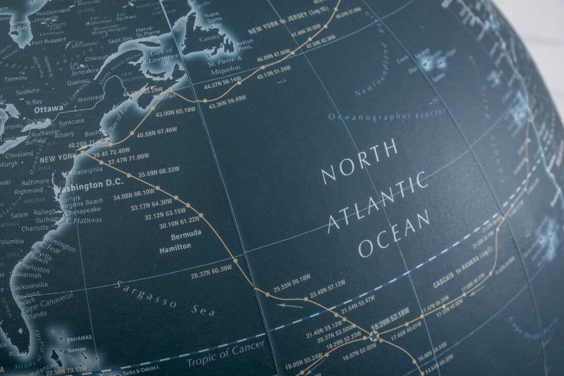 blue globe showing Atlantic Ocean crossing routes