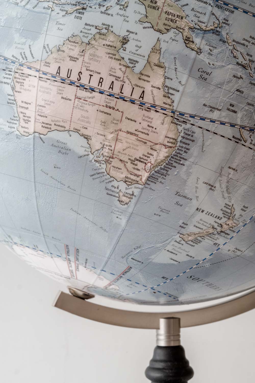 Modern globe showing Australia, on a black wood base and steel arm