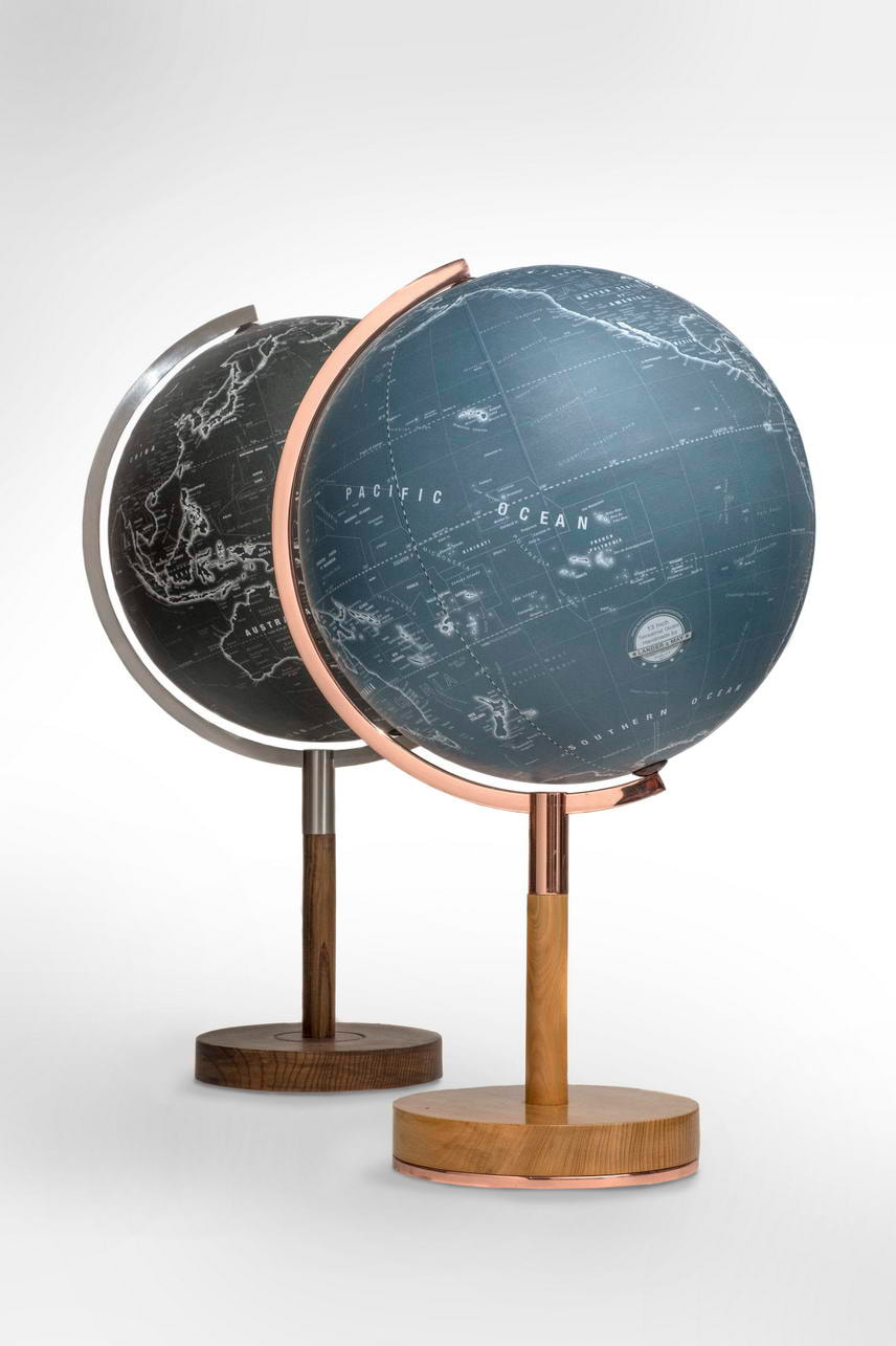 blue profile globe with copper arm in front of black profile globe with nickel arm. Both on stylish base.