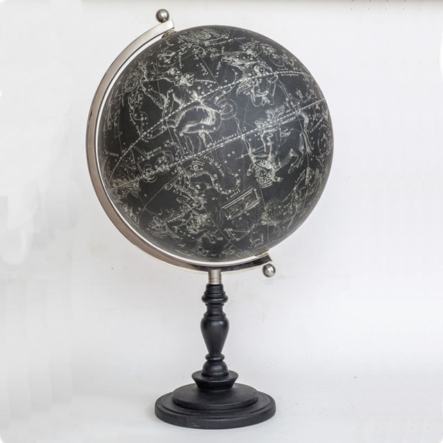a black celestial globe where the stars are silver and the globe black