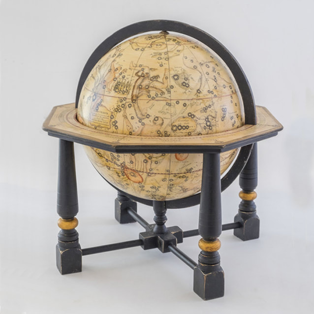 celestial globe with four legged stand, painted black with gold leaf rings