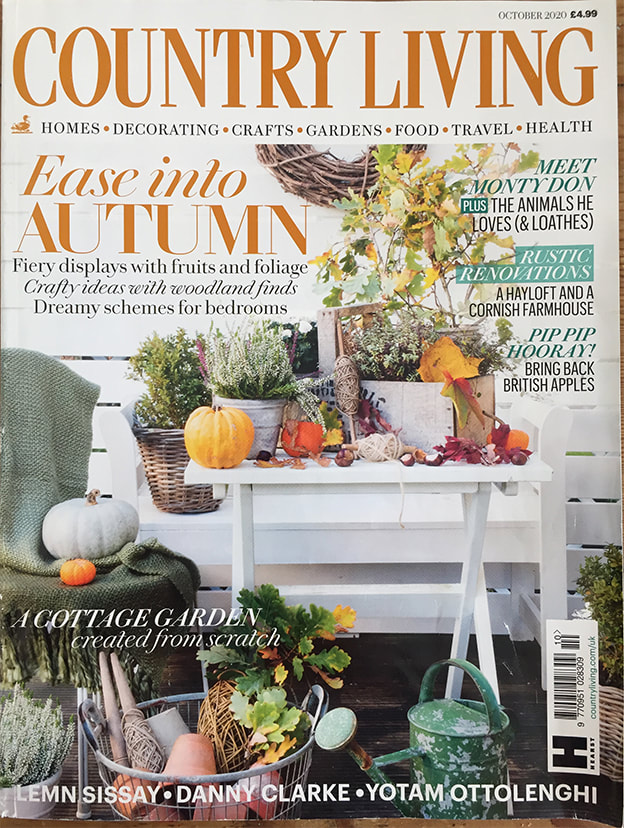 Country living magazine cover with globemaker. Inside is a feature on globe makers Lander and May