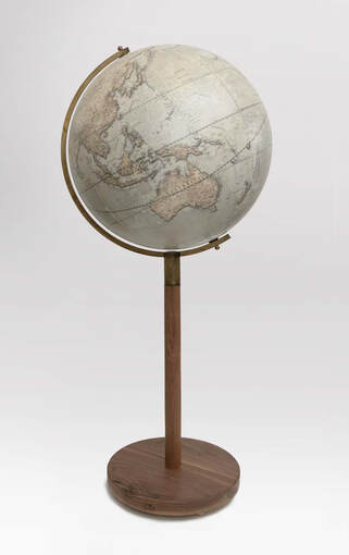 A large 24 inch diameter globe on a walnut base. The globe shows Australia.