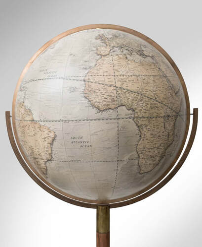 a large 24 inch diameter library globe on a 360 degree stand allowing it to be spun upside down. On a mahogany stand with brass neck.