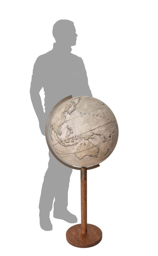 floor standing globe with silhouette figure behind for scale purposes 