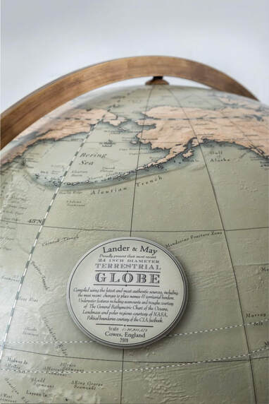 A large globe from globe makers Lander and May. The globe can be spun 360 degrees in its brass cradle .