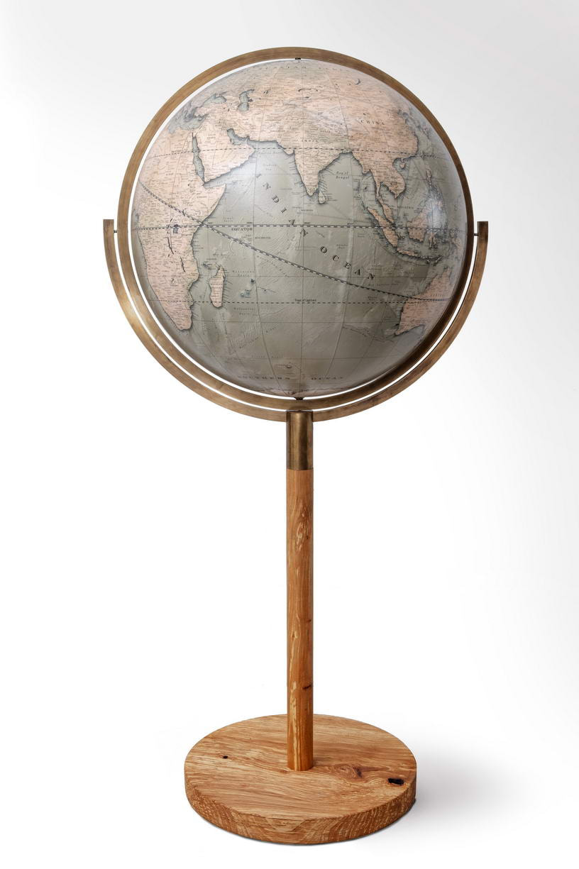 Globe that spins 360 degrees and sits within a double brass ring.