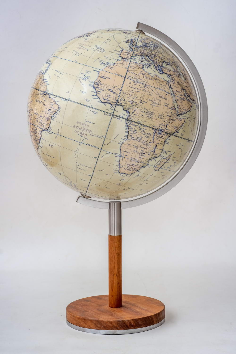 Nordic contemporary globe with wood stand and slim stem. Africa is shown on the globe.