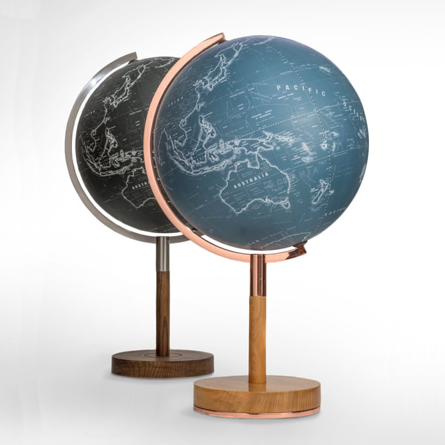 elegant globes, one blue with copper arm and the other black with brushed steel arm. Both sit on stylish wooden bases