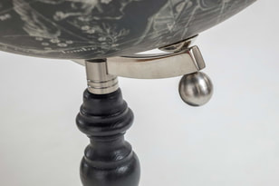 black globe with steel arm and black map with ivory stars