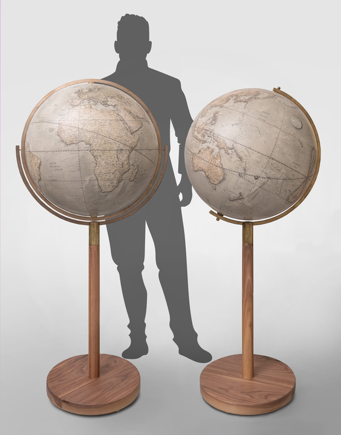two large globes on wooden stands. Behind is a silouhette of a man for scale