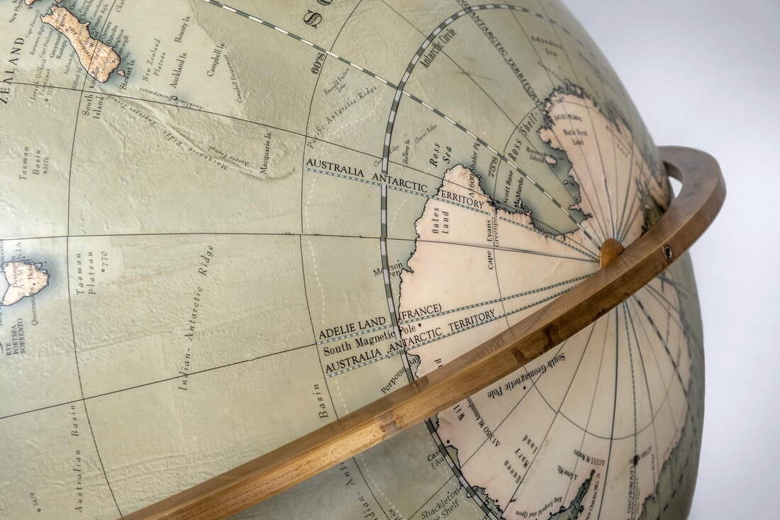 this spinning globe from globe makers Lander and May can be spun upside down, it has an aged brass ring and beech stand.