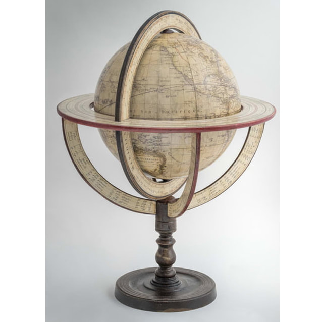old wooden frame that spins upside down allowing the bottom of the globe to be seen